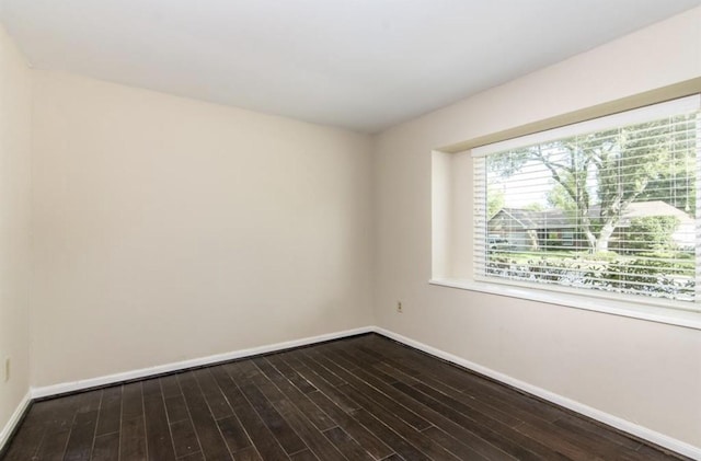 5807 Silver Forest Dr, Houston, TX 77092 - unfurnished room featuring baseboards and dark wood-style flooring
