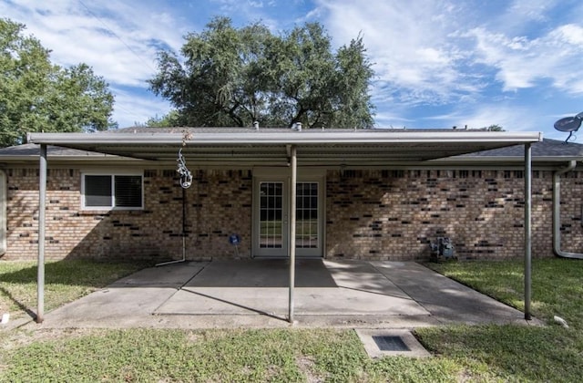 5807 Silver Forest Dr, Houston, TX 77092 - rear view of house with a lawn, brick siding, and a patio