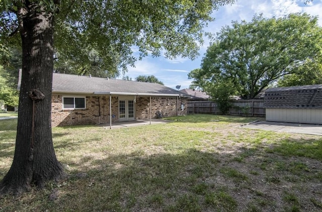 5807 Silver Forest Dr, Houston, TX 77092 - fenced backyard with french doors, a patio, and a storage shed