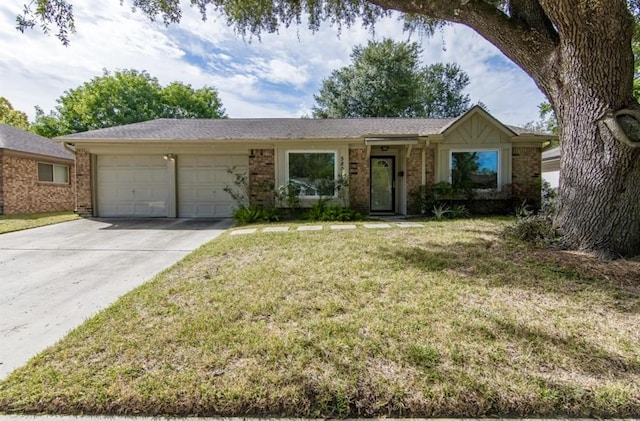 5807 Silver Forest Dr, Houston, TX 77092 - ranch-style house featuring an attached garage, brick siding, driveway, and a front lawn