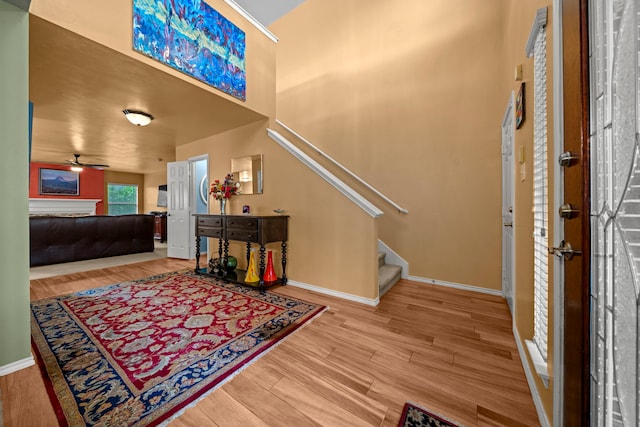 2223 Caroline Park Ln, Spring, TX 77386 - foyer featuring a ceiling fan, wood finished floors, stairs, baseboards, and a high ceiling