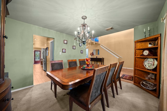 2223 Caroline Park Ln, Spring, TX 77386 - dining area with a chandelier, light colored carpet, and baseboards
