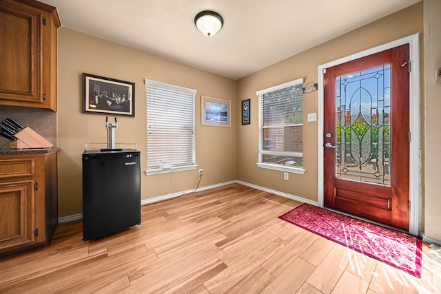 2223 Caroline Park Ln, Spring, TX 77386 - entrance foyer with light wood-type flooring, healthy amount of natural light, and baseboards