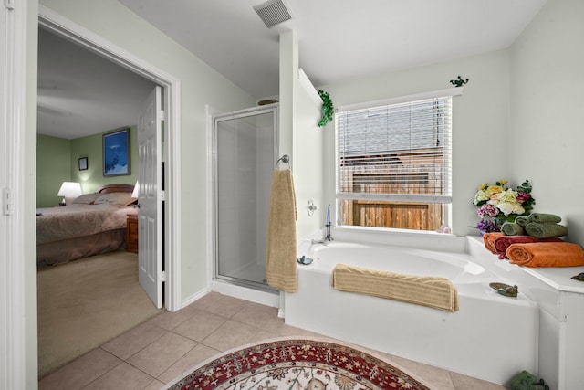 2223 Caroline Park Ln, Spring, TX 77386 - ensuite bathroom featuring a garden tub, a stall shower, and tile patterned flooring