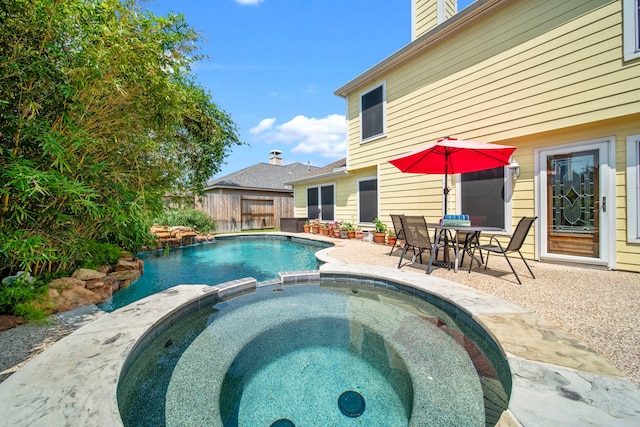 2223 Caroline Park Ln, Spring, TX 77386 - view of pool with a fenced backyard, a pool with connected hot tub, and a patio