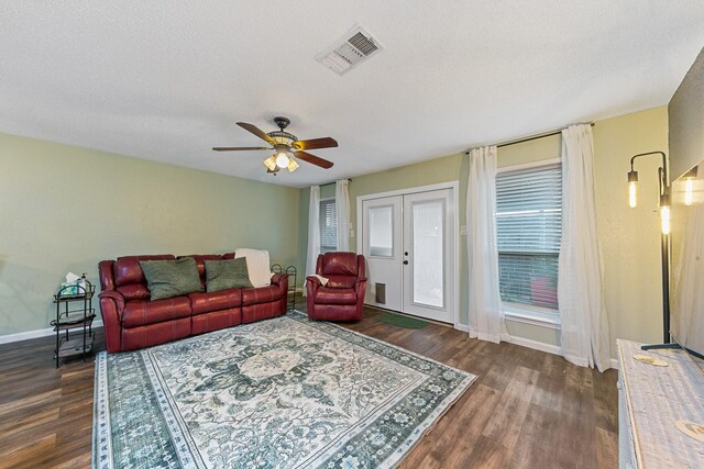 6506 Kentwick Dr, Houston, TX 77084 - living room featuring dark wood finished floors, baseboards, ceiling fan, and a textured ceiling