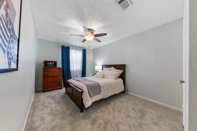 6506 Kentwick Dr, Houston, TX 77084 - bedroom featuring a textured ceiling, light colored carpet, ceiling fan, and baseboards