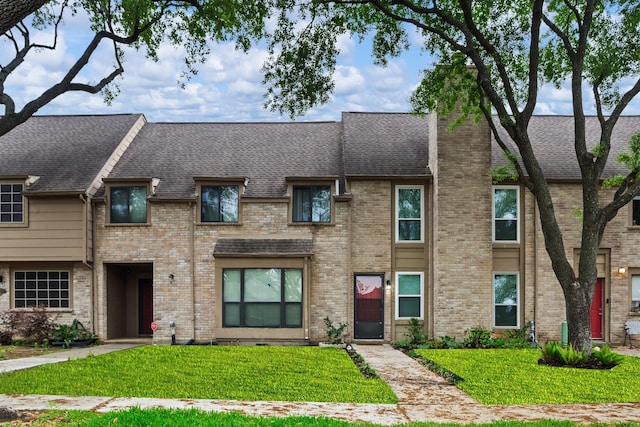 6506 Kentwick Dr, Houston, TX 77084 - townhome / multi-family property with a front yard, roof with shingles, and brick siding