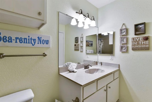 10811 San Luis Pass Rd Unit 2301, Galveston, TX 77554 - bathroom with toilet, vanity, and a textured wall