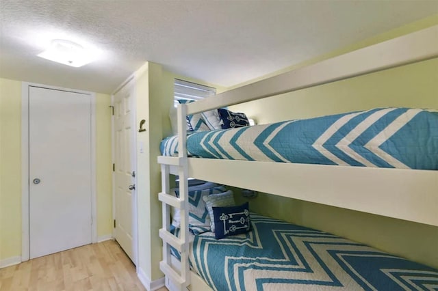 10811 San Luis Pass Rd Unit 2301, Galveston, TX 77554 - bedroom featuring wood finished floors, a textured ceiling, and baseboards