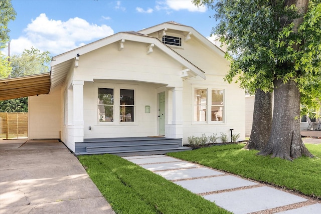 1546 Lawson St, Houston, TX 77023 - view of front of property with driveway, a front lawn, an attached carport, and a porch