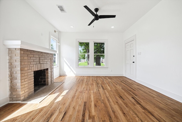 1546 Lawson St, Houston, TX 77023 - unfurnished living room with wood finished floors, a brick fireplace, a ceiling fan, baseboards, and recessed lighting