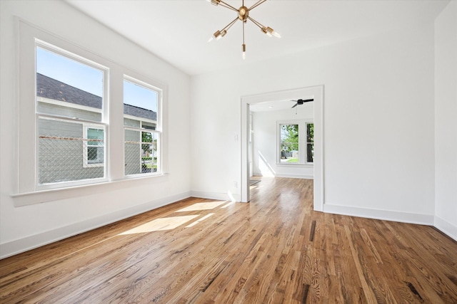 1546 Lawson St, Houston, TX 77023 - spare room with wood finished floors, a chandelier, and baseboards