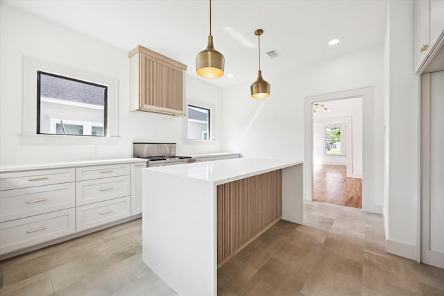 1546 Lawson St, Houston, TX 77023 - kitchen featuring stove, light countertops, light wood-type flooring, recessed lighting, and pendant lighting