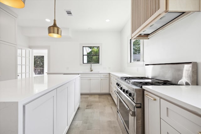 1546 Lawson St, Houston, TX 77023 - kitchen with range with two ovens, recessed lighting, light countertops, white cabinetry, and pendant lighting