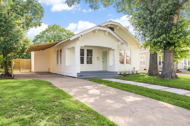 1546 Lawson St, Houston, TX 77023 - view of front facade with driveway, a carport, and a front lawn