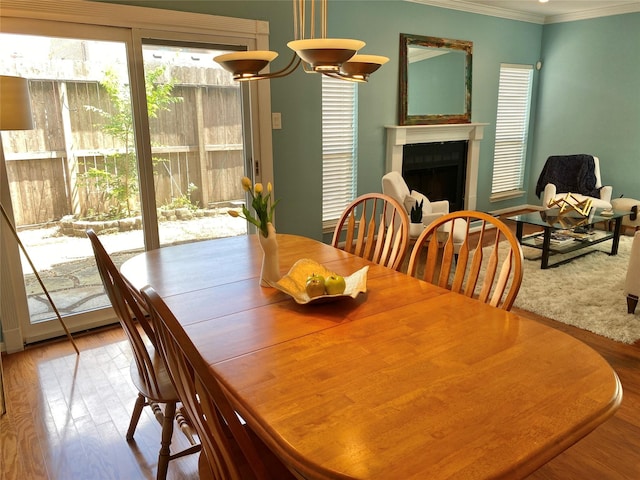 2478 Bering Dr Unit 2478, Houston, TX 77057 - dining room featuring ornamental molding, wood finished floors, and a fireplace