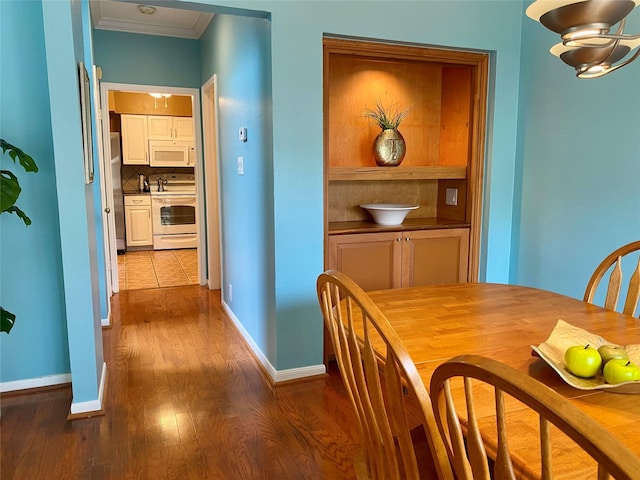 2478 Bering Dr Unit 2478, Houston, TX 77057 - dining room with ornamental molding, baseboards, and dark wood finished floors