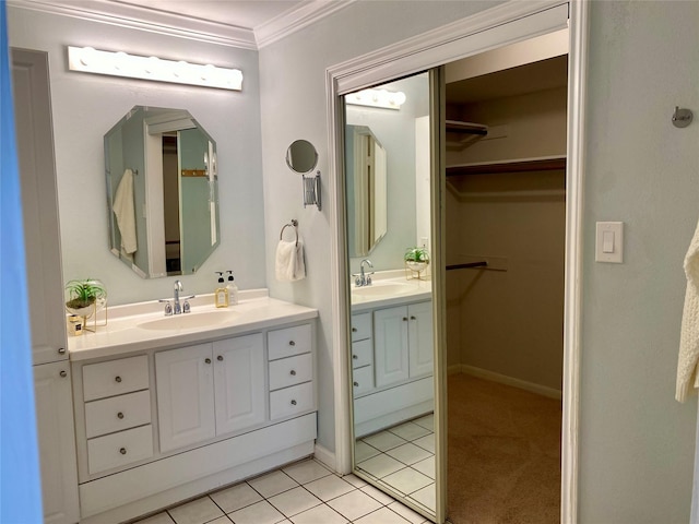 2478 Bering Dr Unit 2478, Houston, TX 77057 - full bath featuring two vanities, ornamental molding, a walk in closet, tile patterned flooring, and baseboards