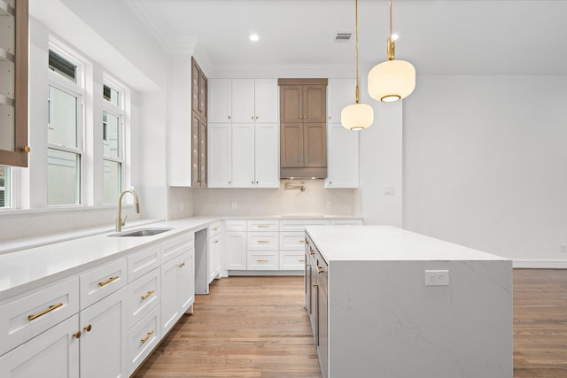 1013 E 28th St, Houston, TX 77009 - kitchen with a sink, light wood-style floors, light countertops, white cabinets, and recessed lighting