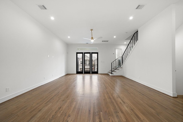 1013 E 28th St, Houston, TX 77009 - unfurnished living room with ceiling fan, wood finished floors, recessed lighting, baseboards, and stairway