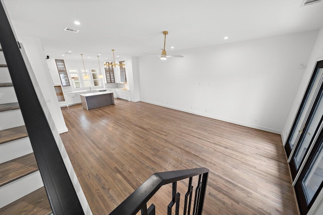 1013 E 28th St, Houston, TX 77009 - unfurnished living room with a ceiling fan, wood finished floors, stairway, baseboards, and recessed lighting