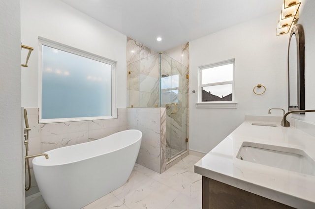 1013 E 28th St, Houston, TX 77009 - bathroom with double vanity, a freestanding tub, a marble finish shower, marble finish floors, and wainscoting