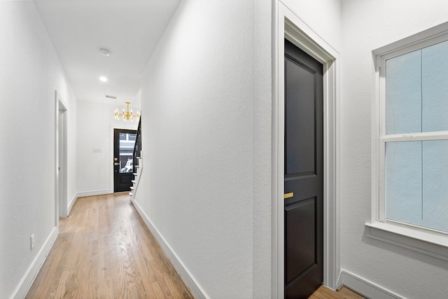 1013 E 28th St, Houston, TX 77009 - corridor featuring light wood-style floors, a chandelier, baseboards, and recessed lighting