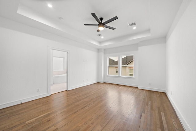 1013 E 28th St, Houston, TX 77009 - unfurnished room featuring a raised ceiling, wood finished floors, ceiling fan, recessed lighting, and baseboards