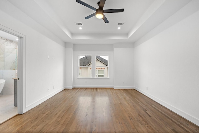 1013 E 28th St, Houston, TX 77009 - spare room featuring a raised ceiling, a ceiling fan, wood finished floors, baseboards, and recessed lighting