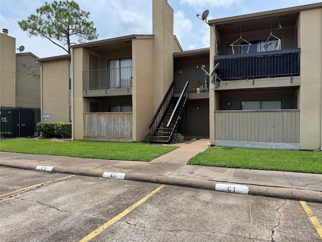 3300 Pebblebrook Dr Unit 106, Seabrook, TX 77586 - view of building exterior featuring uncovered parking and stairs