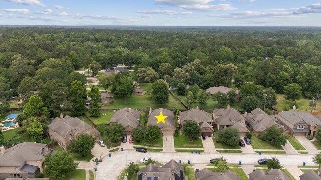 122 Jacobs Meadow Dr, Conroe, TX 77384 - aerial perspective of suburban area featuring a heavily wooded area