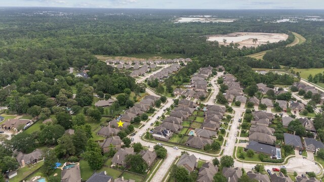 122 Jacobs Meadow Dr, Conroe, TX 77384 - aerial view of property and surrounding area featuring a heavily wooded area and nearby suburban area