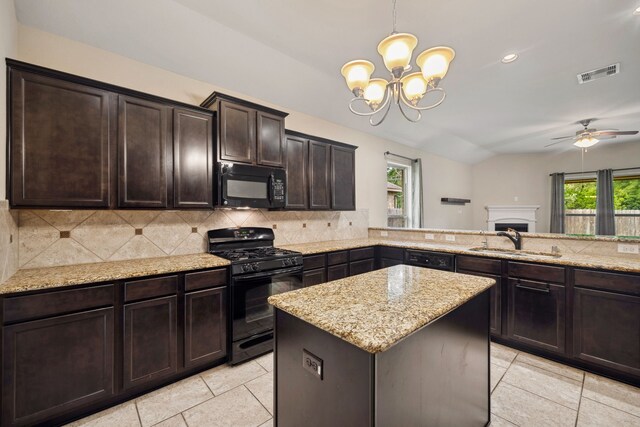122 Jacobs Meadow Dr, Conroe, TX 77384 - kitchen with black appliances, a sink, backsplash, light tile patterned floors, and vaulted ceiling