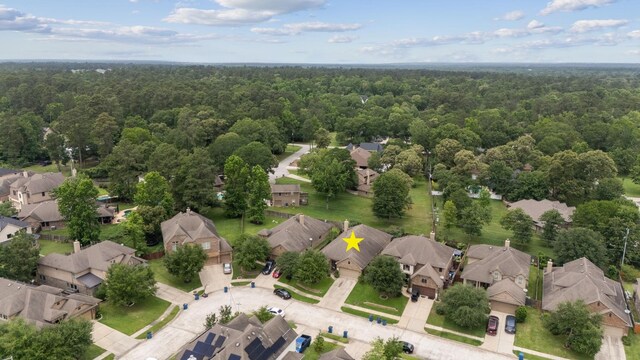 122 Jacobs Meadow Dr, Conroe, TX 77384 - aerial perspective of suburban area featuring a heavily wooded area