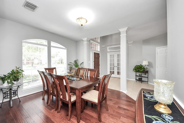 8742 Melting Shadows Ln, Houston, TX 77095 - dining space featuring decorative columns, wood finished floors, french doors, and baseboards