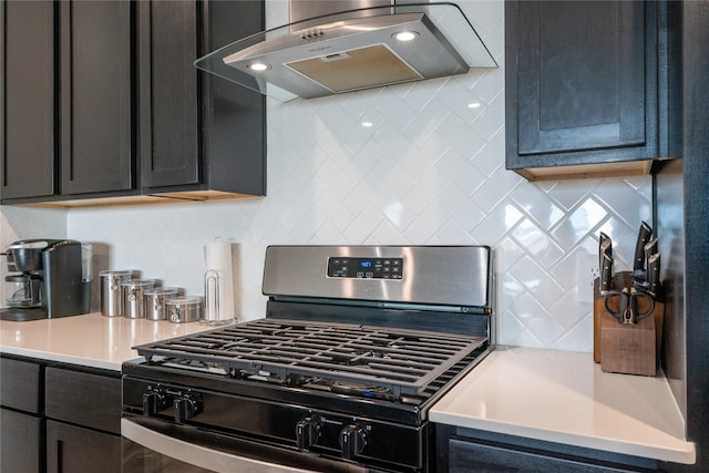 12327 Brandenburg Gate Dr, Houston, TX 77047 - kitchen with range with gas cooktop, ventilation hood, light countertops, and decorative backsplash