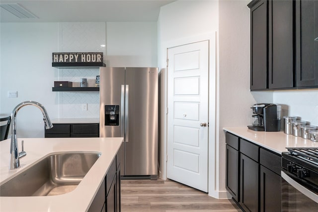 12327 Brandenburg Gate Dr, Houston, TX 77047 - kitchen featuring stainless steel fridge with ice dispenser, a sink, decorative backsplash, and light wood-style flooring