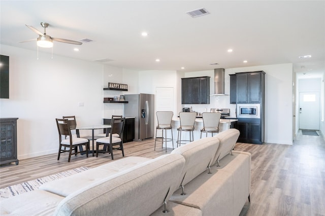 12327 Brandenburg Gate Dr, Houston, TX 77047 - living room featuring light wood-type flooring, ceiling fan, recessed lighting, and baseboards