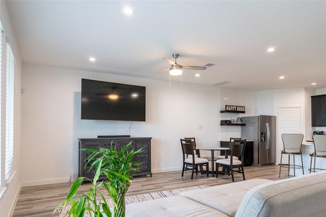 12327 Brandenburg Gate Dr, Houston, TX 77047 - living area with light wood-style floors, ceiling fan, recessed lighting, and baseboards