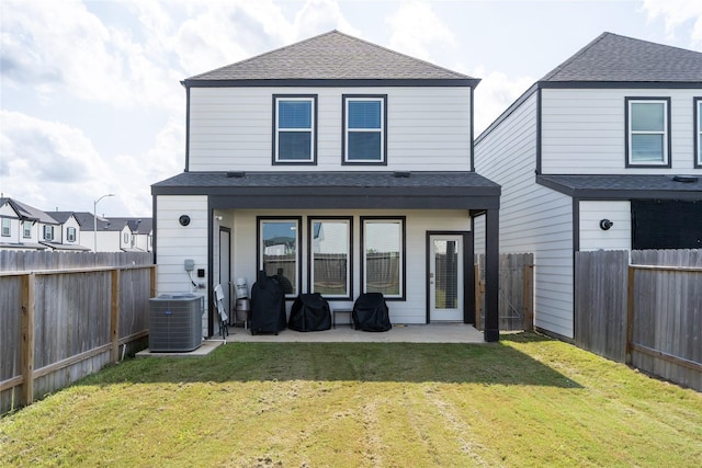 12327 Brandenburg Gate Dr, Houston, TX 77047 - rear view of house featuring a shingled roof, a patio, and central AC unit
