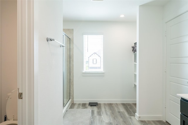 12327 Brandenburg Gate Dr, Houston, TX 77047 - full bath with a stall shower, vanity, wood finished floors, baseboards, and recessed lighting