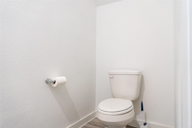 12327 Brandenburg Gate Dr, Houston, TX 77047 - bathroom featuring baseboards, toilet, and wood finished floors