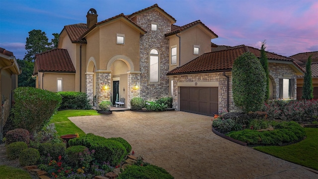16119 Villa Fontana Way, Houston, TX 77068 - mediterranean / spanish-style house featuring stone siding, a tiled roof, stucco siding, a chimney, and a garage