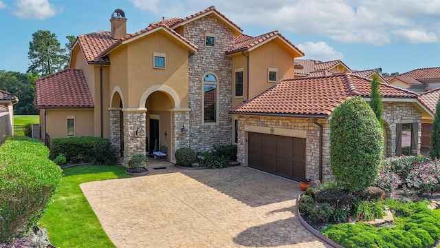 16119 Villa Fontana Way, Houston, TX 77068 - mediterranean / spanish-style house featuring stucco siding, a chimney, stone siding, and a garage