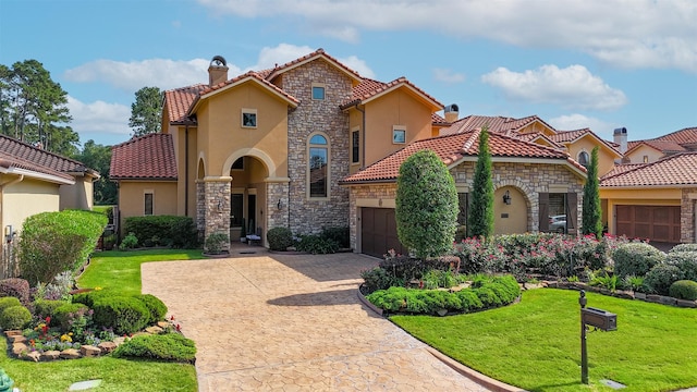 16119 Villa Fontana Way, Houston, TX 77068 - mediterranean / spanish-style house with stone siding, an attached garage, a tile roof, a front yard, and stucco siding
