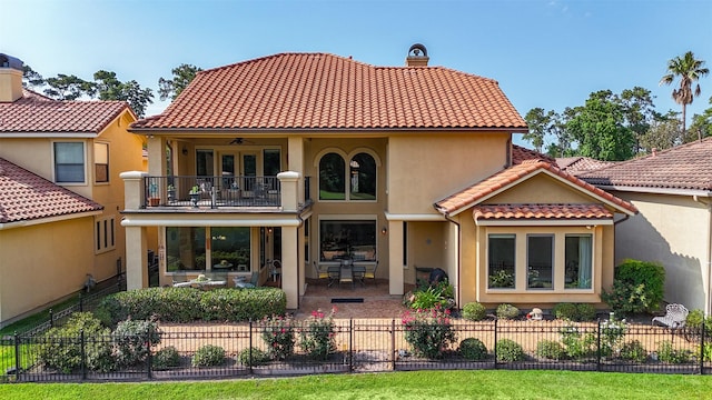 16119 Villa Fontana Way, Houston, TX 77068 - rear view of property featuring a balcony, a chimney, stucco siding, and a tiled roof
