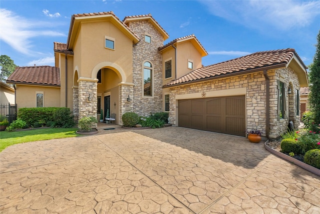 16119 Villa Fontana Way, Houston, TX 77068 - mediterranean / spanish-style home with stucco siding, a tile roof, and stone siding