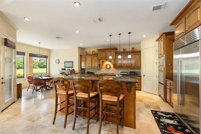 16119 Villa Fontana Way, Houston, TX 77068 - kitchen featuring built in appliances, brown cabinets, decorative backsplash, a center island, and dark stone countertops