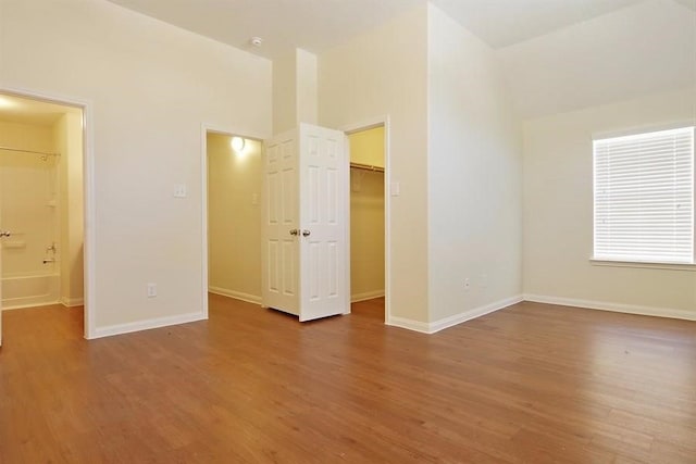 15415 Bammel Oaks Ct, Houston, TX 77014 - unfurnished bedroom with wood finished floors, a walk in closet, baseboards, a closet, and ensuite bath